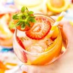 This White Wine Sangria recipe is made with juicy strawberries, oranges, and peaches as well as sweet simple syrup, apricot brandy, and a splash of club soda or seltzer! It's an easy and refreshing summer wine cocktail.