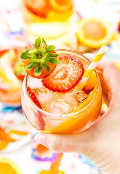 This White Wine Sangria recipe is made with juicy strawberries, oranges, and peaches as well as sweet simple syrup, apricot brandy, and a splash of club soda or seltzer! It's an easy and refreshing summer wine cocktail.