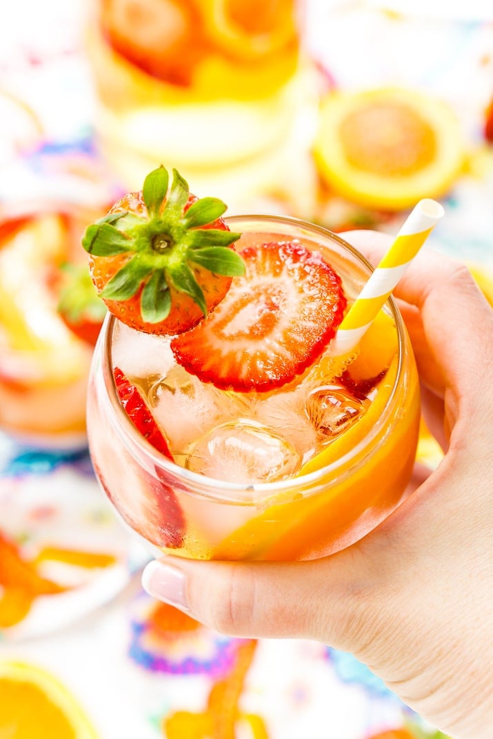 This White Wine Sangria recipe is made with juicy strawberries, oranges, and peaches as well as sweet simple syrup, apricot brandy, and a splash of club soda or seltzer! It's an easy and refreshing summer wine cocktail.