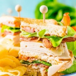 This Club Sandwich Recipe is an easy and classic sandwich made with hickory smoked turkey breast, Swiss cheese, thick-cut bacon, lettuce, tomato, and mayonnaise.
