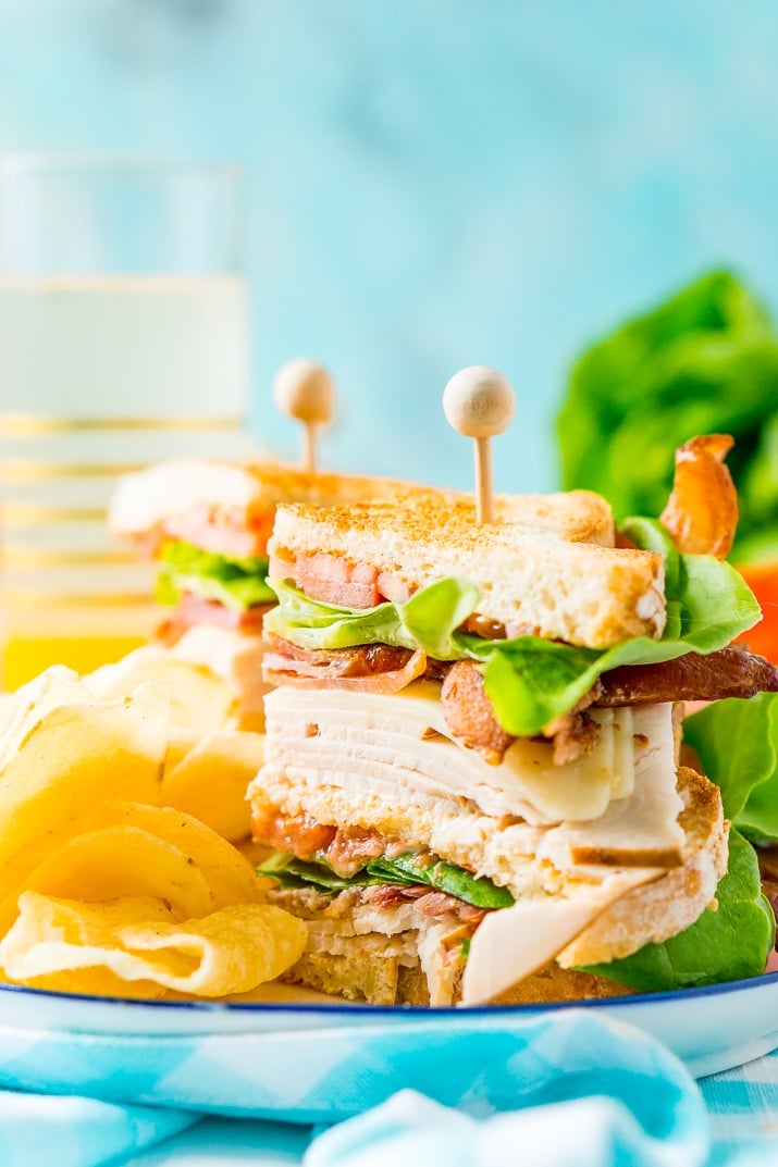 This Club Sandwich Recipe is an easy and classic sandwich made with hickory smoked turkey breast, Swiss cheese, thick-cut bacon, lettuce, tomato, and mayonnaise.