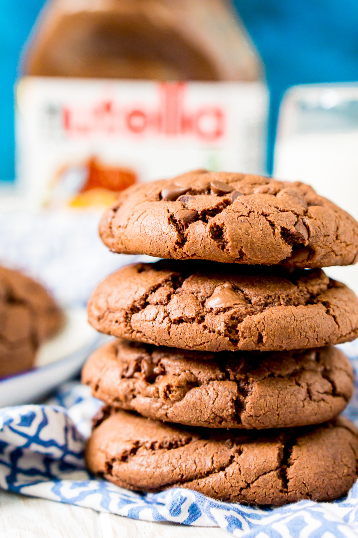 Close up photo of a stack of Nutella stuffed chocolate cookies on a blue and white napkin.