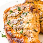 This Pork Chop Marinade makes meat juicy, tender, and super flavorful. Made with apple cider vinegar, olive oil, garlic powder, ground mustard, coriander, sea salt, brown sugar and honey, you can whip it up for summer cookouts or weeknight dinners.