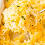 This Hashbrown Casserole will be an instant hit with the family! Made with hashbrown potatoes, cheddar and Colby Jack cheeses, cream of chicken soup, and a whole lot of butter. This gooey breakfast or side dish will have everyone begging for more!