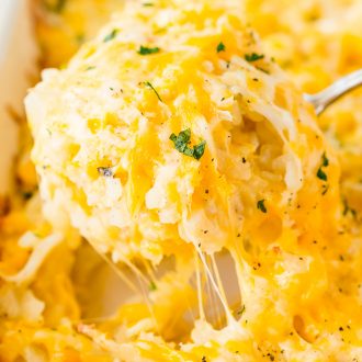 This Hashbrown Casserole will be an instant hit with the family! Made with hashbrown potatoes, cheddar and Colby Jack cheeses, cream of chicken soup, and a whole lot of butter. This gooey breakfast or side dish will have everyone begging for more!