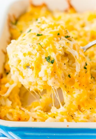 This Hashbrown Casserole will be an instant hit with the family! Made with hashbrown potatoes, cheddar and Colby Jack cheeses, cream of chicken soup, and a whole lot of butter. This gooey breakfast or side dish will have everyone begging for more!