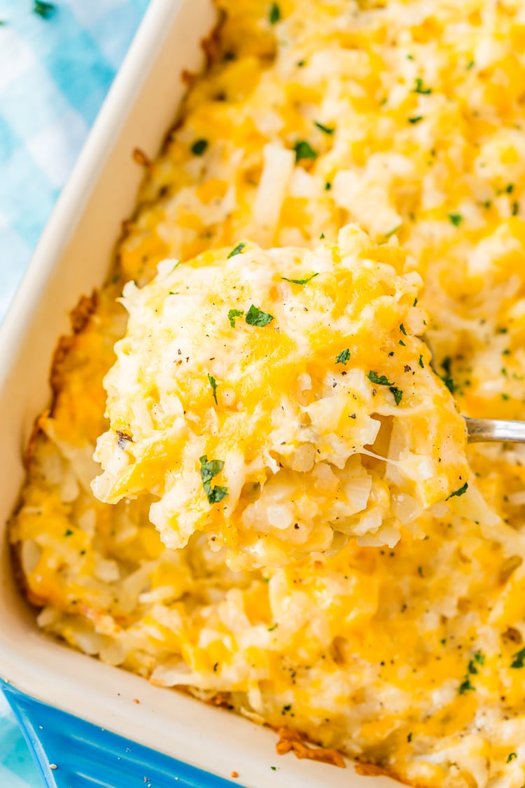 This Hashbrown Casserole will be an instant hit with the family! Made with hashbrown potatoes, cheddar and Colby Jack cheeses, cream of chicken soup, and a whole lot of butter. This gooey breakfast or side dish will have everyone begging for more!