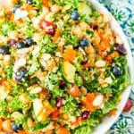 Chopped Kale Salad is loaded with kale, red grapes, orange bell peppers, white quinoa, grated carrots, European cucumbers, Craisins, and sliced almonds. Enjoy it as a wholesome side dish or top with chicken or chickpeas for a light and satisfying meal.