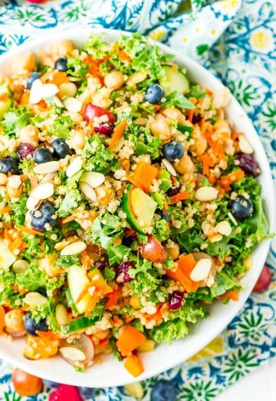 Chopped Kale Salad is loaded with kale, red grapes, orange bell peppers, white quinoa, grated carrots, European cucumbers, Craisins, and sliced almonds. Enjoy it as a wholesome side dish or top with chicken or chickpeas for a light and satisfying meal.