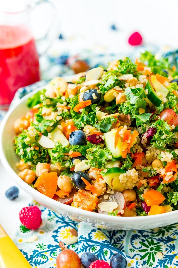 Chopped Kale Salad is loaded with kale, red grapes, orange bell peppers, white quinoa, grated carrots, European cucumbers, Craisins, and sliced almonds. Enjoy it as a wholesome side dish or top with chicken or chickpeas for a light and satisfying meal.