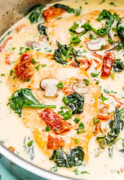 Creamy Tuscan Chicken is a gourmet homemade meal that takes just 30 minutes! Made with chicken, sundried tomatoes, spinach, mushrooms, spices, cheese, and heavy cream, this is a perfect family-friendly recipe to whip up on any night of the week.