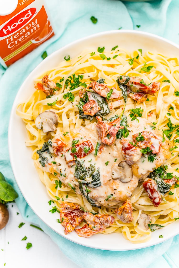 Creamy Tuscan Chicken is a gourmet homemade meal that takes just 30 minutes! Made with chicken, sundried tomatoes, spinach, mushrooms, spices, cheese, and heavy cream, this is a perfect family-friendly recipe to whip up on any night of the week.