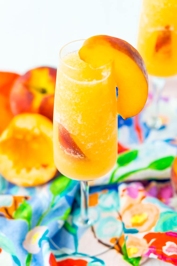 This Peach Bellini Slushies recipe is a frozen take on the classic brunch cocktail! Made in the blender with just 4 ingredients, this easy champagne cocktail is a refreshingly boozy beverage to enjoy all summer.