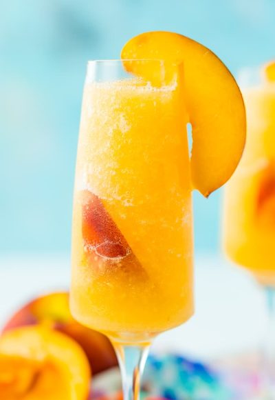 This Peach Bellini Slushies recipe is a frozen take on the classic brunch cocktail! Made in the blender with just 4 ingredients, this easy champagne cocktail is a refreshingly boozy beverage to enjoy all summer.