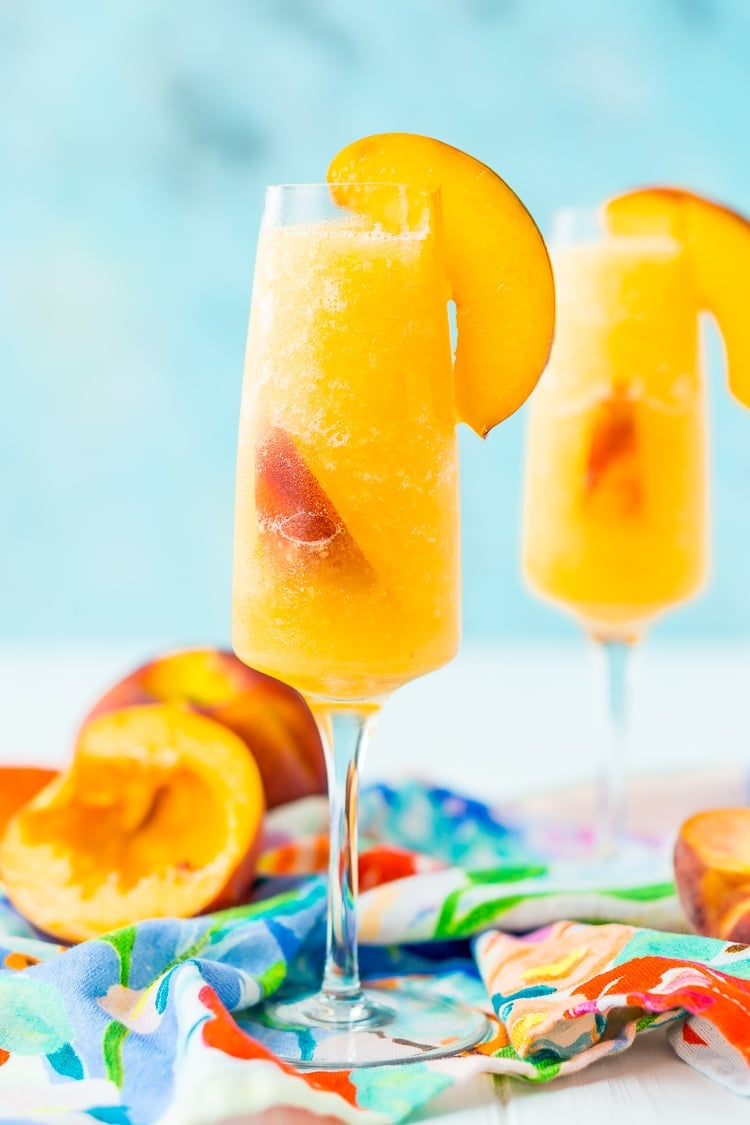 This Peach Bellini Slushies recipe is a frozen take on the classic brunch cocktail! Made in the blender with just 4 ingredients, this easy champagne cocktail is a refreshingly boozy beverage to enjoy all summer.