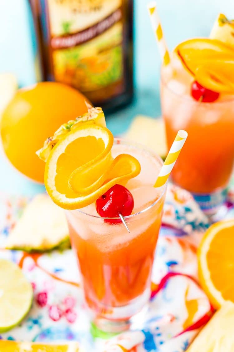 Planter's punch served in a glass with cherry and orange garnishes.