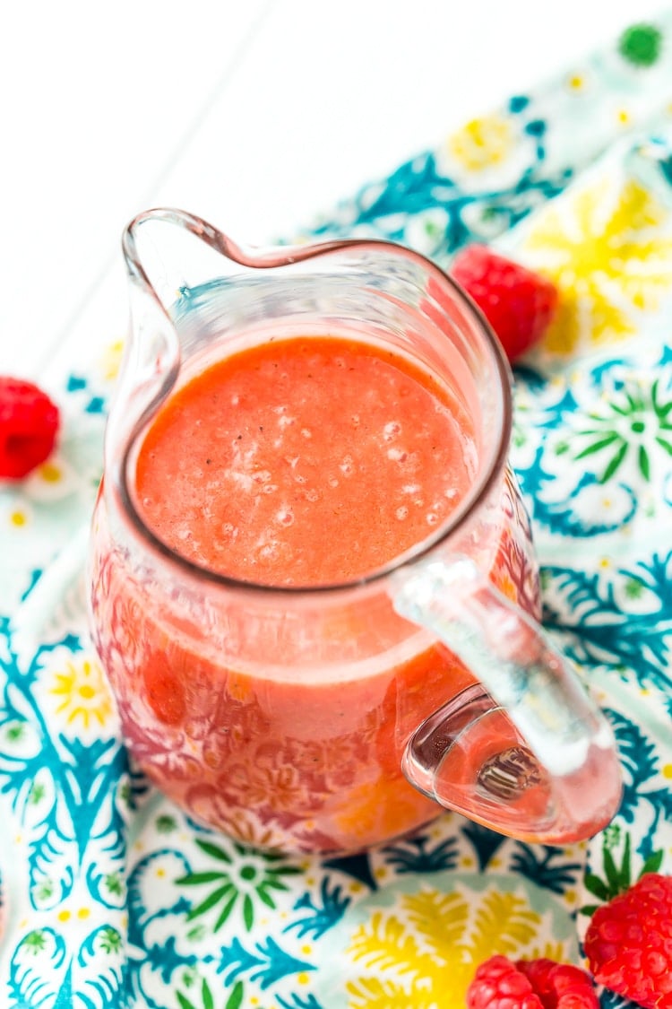 Raspberry Vinaigrette Dressing is delicious on summer salads and made with fresh raspberries, honey, red wine vinegar, olive oil, sea salt, black pepper, and garlic powder.