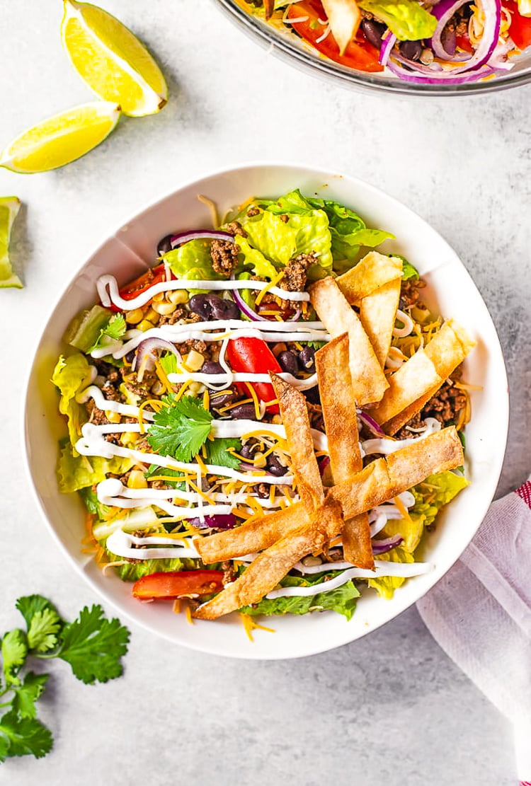 Taco Salad is the easiest way to rock Taco Tuesday like a pro! It's loaded with fresh veggies, cheese, and seasoned meat with crunchy tortilla strips! Whether you're meal-prepping or looking for a quick weekday dinner, this recipe is a real crowd pleaser.