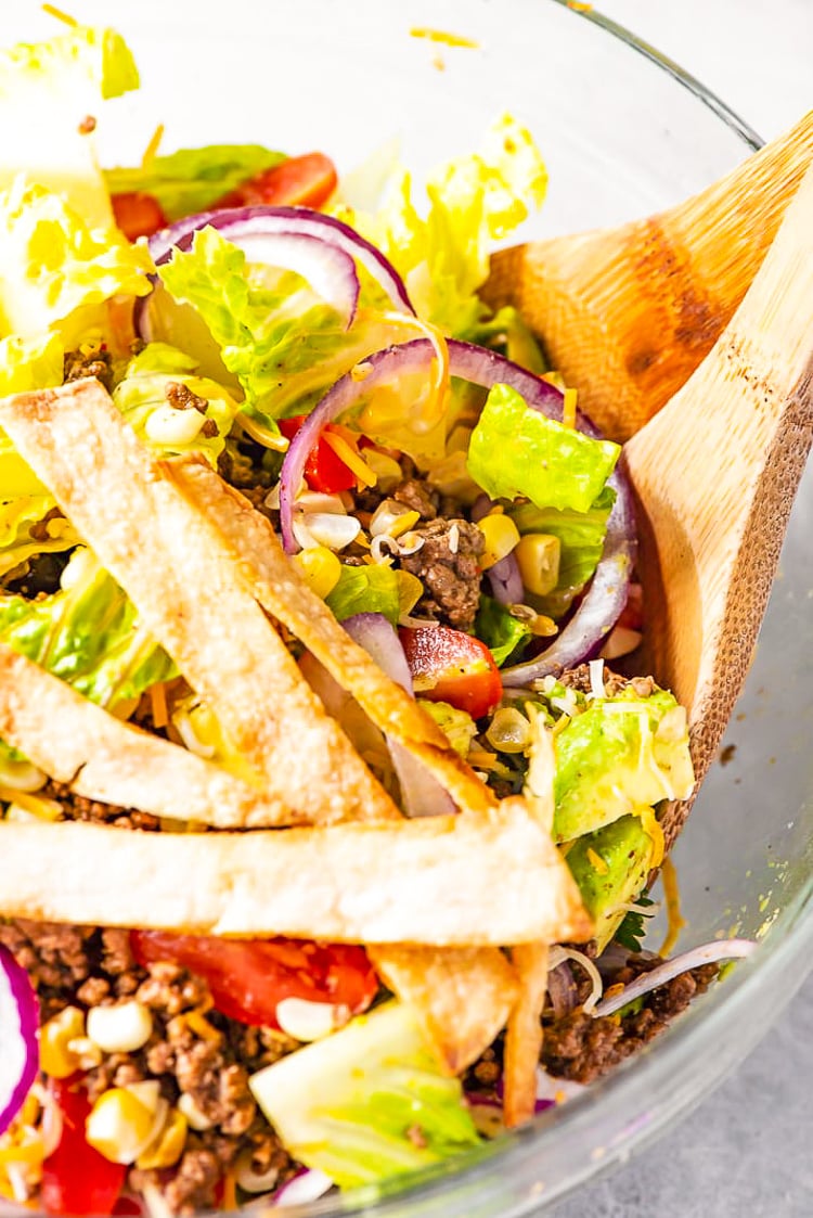 Taco Salad is the easiest way to rock Taco Tuesday like a pro! It's loaded with fresh veggies, cheese, and seasoned meat with crunchy tortilla strips! Whether you're meal-prepping or looking for a quick weekday dinner, this recipe is a real crowd pleaser.