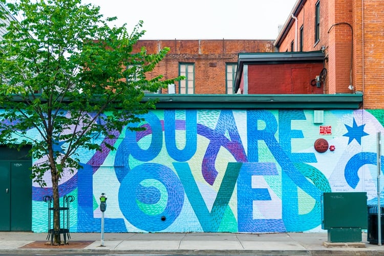 Mural on building wall saying "You are Loved"