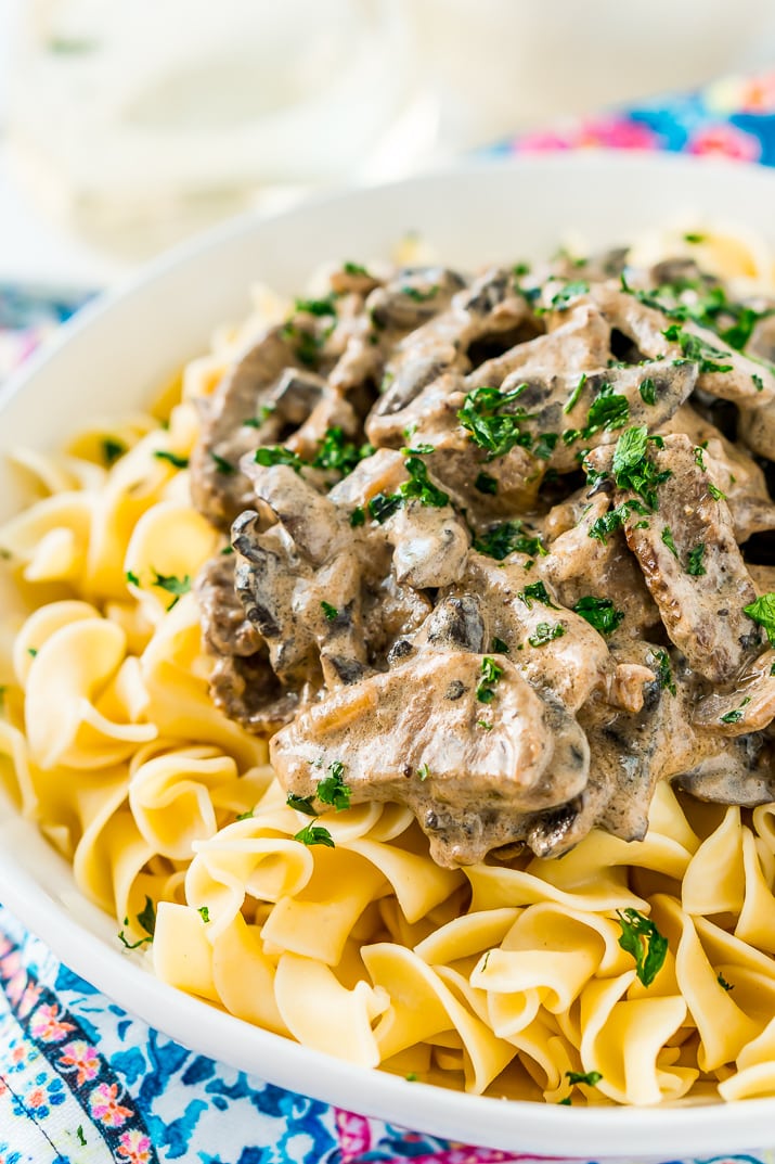 Beef Stroganoff is a delicious dinner recipe made with tender ribeye steak sautéed in a buttery mushroom and sour cream sauce and served over egg noodles.