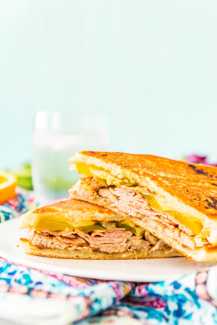 This Cuban Sandwich is loaded with smoked ham, swiss cheese, mojo pork, mustard, and pickles, and then grilled to melty perfection!