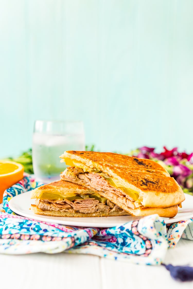 This Cuban Sandwich is loaded with smoked ham, swiss cheese, mojo pork, mustard, and pickles, and then grilled to melty perfection!