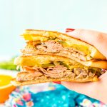 This Cuban Sandwich is loaded with smoked ham, swiss cheese, mojo pork, mustard, and pickles, and then grilled to melty perfection!