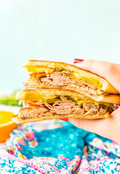 This Cuban Sandwich is loaded with smoked ham, swiss cheese, mojo pork, mustard, and pickles, and then grilled to melty perfection!