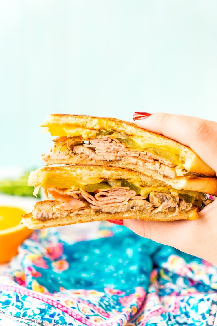 This Cuban Sandwich is loaded with smoked ham, swiss cheese, mojo pork, mustard, and pickles, and then grilled to melty perfection!