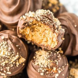 Peanut Butter Balls are a classic no-bake treat made with graham crackers, creamy peanut butter, powdered sugar, and chocolate! Perfect for the holidays!