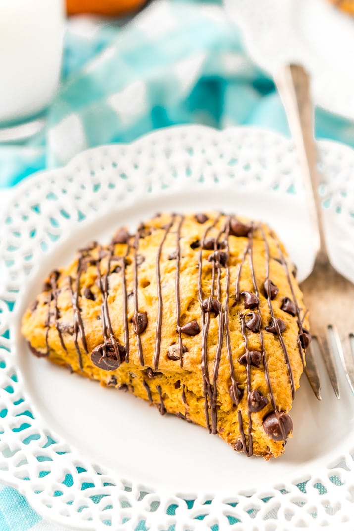 Pumpkin Scones are the sophisticated way to enjoy pumpkin and spice this season! This simple recipe calls for dark and semi-sweet chocolate chips so you can indulge your chocolate cravings and get your pumpkin fix morning, noon, or night.