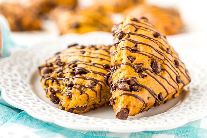 Pumpkin Scones are the sophisticated way to enjoy pumpkin and spice this season! This simple recipe calls for dark and semi-sweet chocolate chips so you can indulge your chocolate cravings and get your pumpkin fix morning, noon, or night.