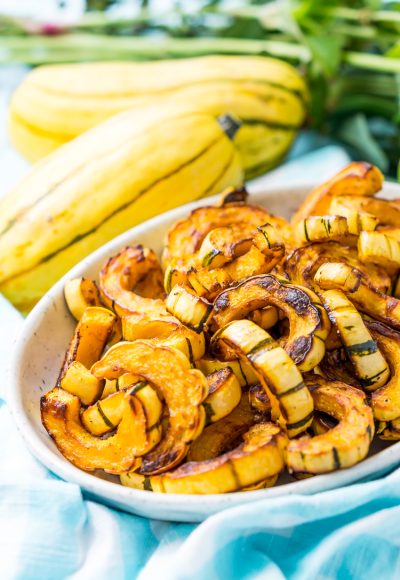 Delicata Squash is a small, easy to cook squash that's sweet and tender and doesn't require peeling because you can eat the skin! Roast it with salt, pepper, and olive oil or cinnamon, brown sugar, and coconut oil for an even sweeter side dish!