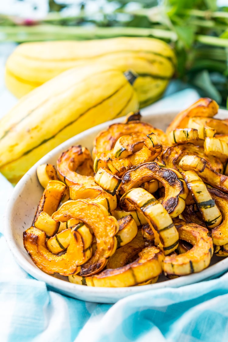 Delicata Squash is a small, easy to cook squash that's sweet and tender and doesn't require peeling because you can eat the skin! Roast it with salt, pepper, and olive oil or cinnamon, brown sugar, and coconut oil for an even sweeter side dish!