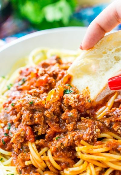 This Easy Spaghetti Bolognese Sauce Recipe is a simple take on an authentic and traditional Italian meal. Loaded with ground beef and spices and laced with Merlot wine, this quick tomato based sauce is bound to be a wholesome family favorite.