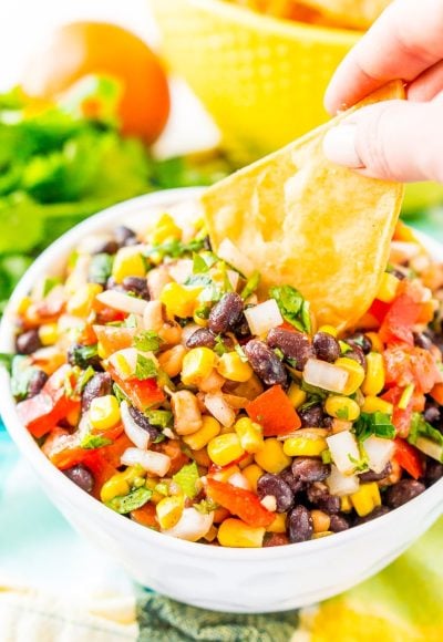 Cowboy Caviar is a Mexican-inspired dip or topping that’s loaded with beans, corn, onion, peppers, tomato, cilantro, and a handful of zesty spices! It’s the perfect addition to game day snacks, barbecues, taco night, and more!