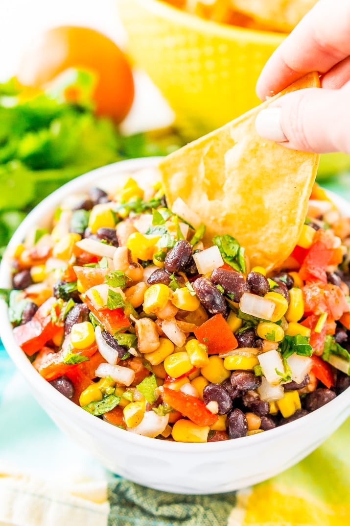 Cowboy Caviar is a Mexican-inspired dip or topping that’s loaded with beans, corn, onion, peppers, tomato, cilantro, and a handful of zesty spices! It’s the perfect addition to game day snacks, barbecues, taco night, and more!