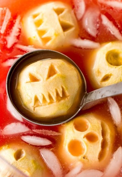 Shrunken Head Party Punch doubles as a delicious drink and a creepy conversation piece! Made with fruit juices, lemon-lime soda, and a splash of grenadine, the best part of this beverage is the floating “shrunken heads” which are made with baked apples!