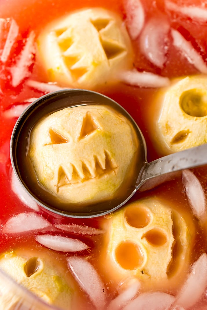 Shrunken Head Party Punch doubles as a delicious drink and a creepy conversation piece! Made with fruit juices, lemon-lime soda, and a splash of grenadine, the best part of this beverage is the floating “shrunken heads” which are made with baked apples!