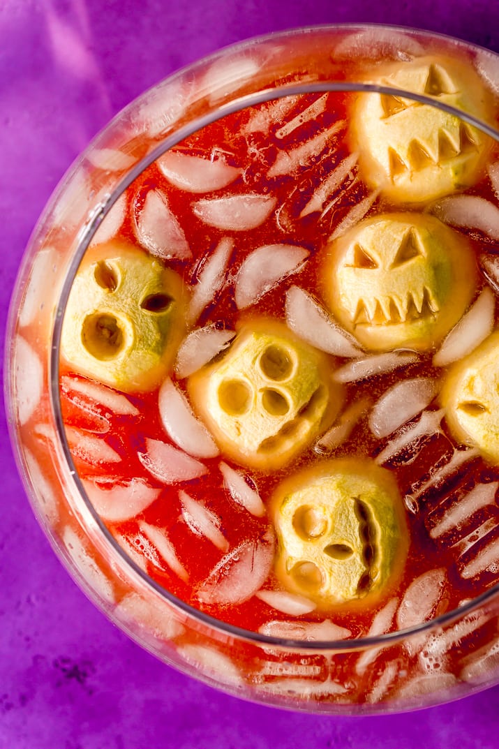 Shrunken Head Party Punch doubles as a delicious drink and a creepy conversation piece! Made with fruit juices, lemon-lime soda, and a splash of grenadine, the best part of this beverage is the floating “shrunken heads” which are made with baked apples!