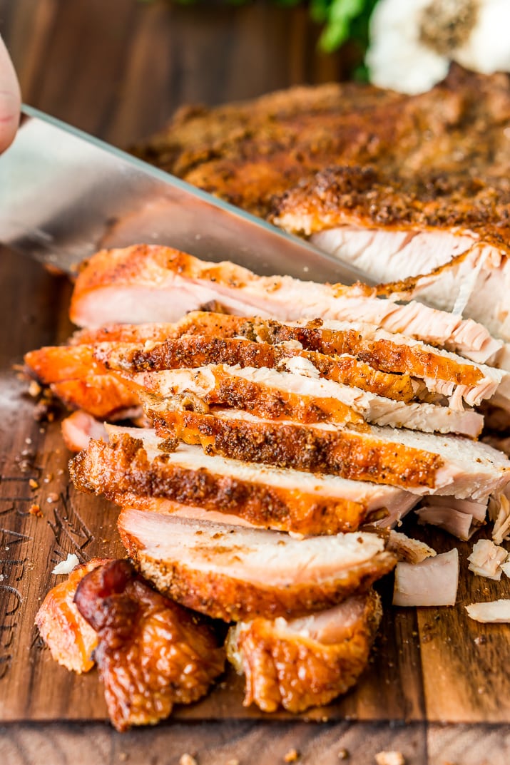 This Smoked Turkey Breast is made with a warm and spicy dry rub that adds tons of flavor to the tender and juicy meat.