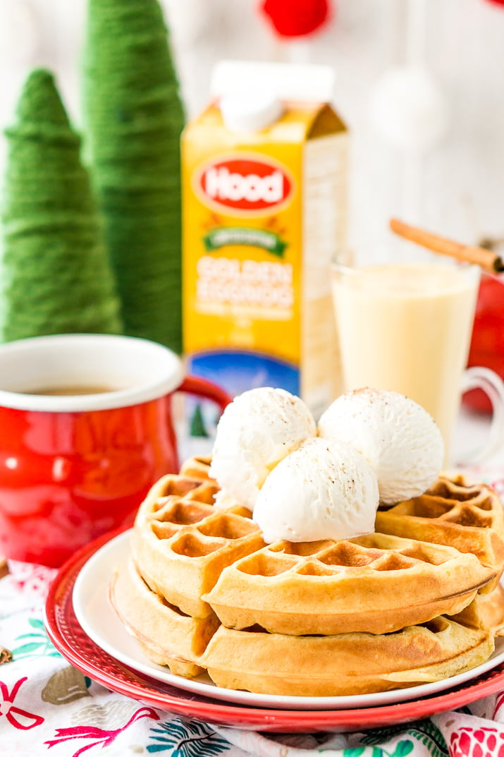 Eggnog Waffles are crisp and golden on the outside and fluffy on the inside, topped with whipped cream and spiced vanilla syrup!