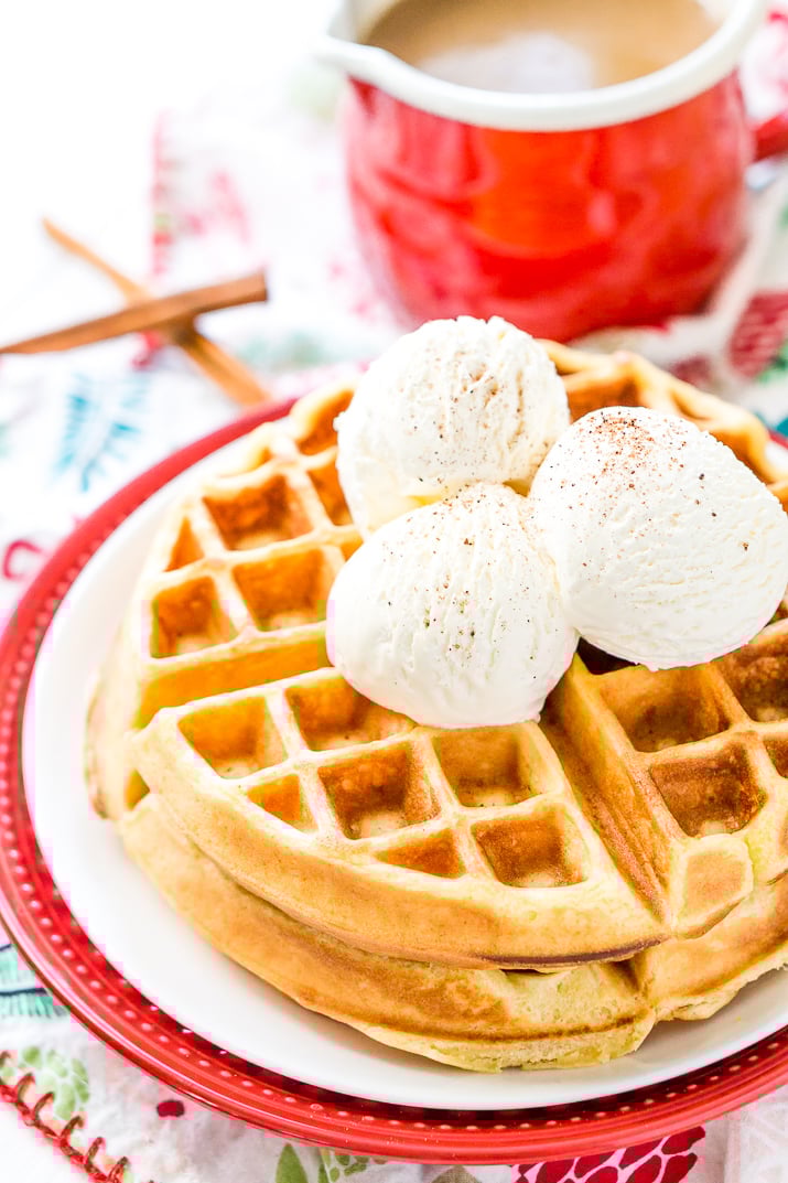 Eggnog Waffles are crisp and golden on the outside and fluffy on the inside, topped with whipped cream and spiced vanilla syrup!