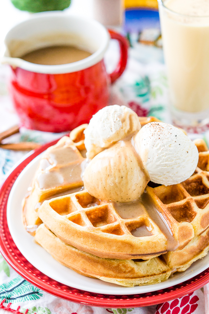 Eggnog Waffles are crisp and golden on the outside and fluffy on the inside, topped with whipped cream and spiced vanilla syrup!