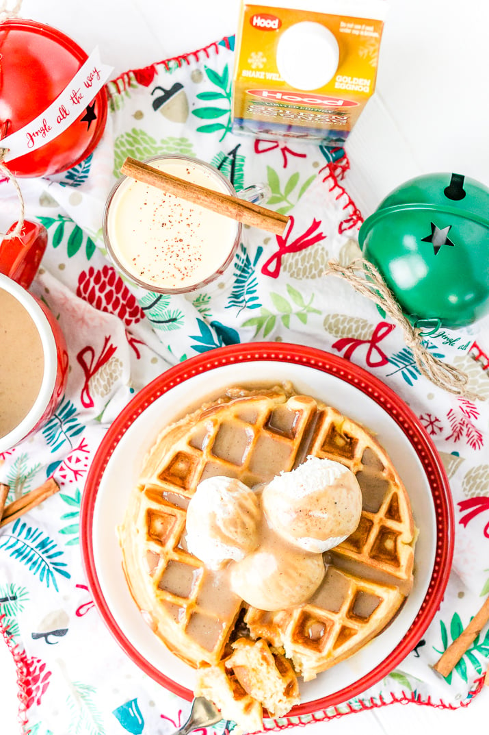 Eggnog Waffles are crisp and golden on the outside and fluffy on the inside, topped with whipped cream and spiced vanilla syrup!