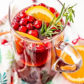 This Christmas Sangria is made with red wine, fruit juices, brandy, soda, and fruit for a delicious big-batch cocktail that's perfect for parties.