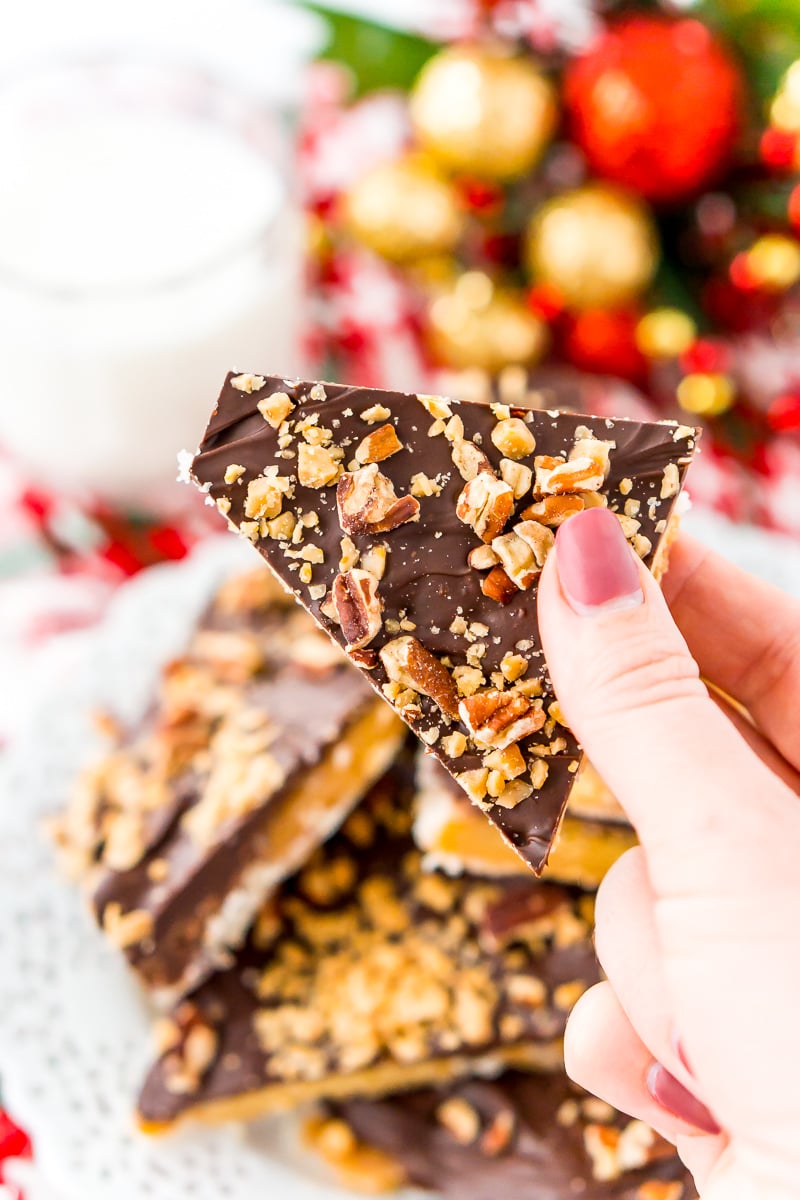 Woman's hand holding a piece of Christmas crack