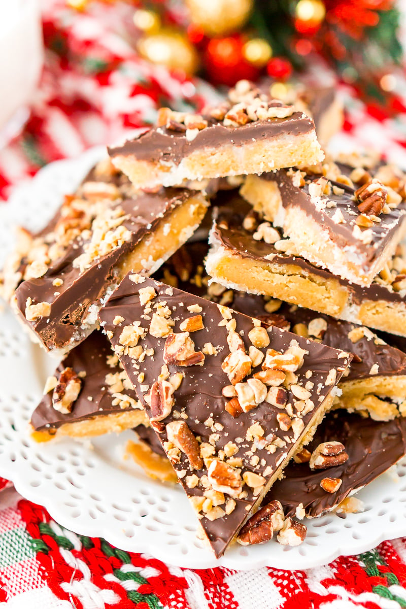 Shortbread Christmas Crack on white plate with holiday decorations