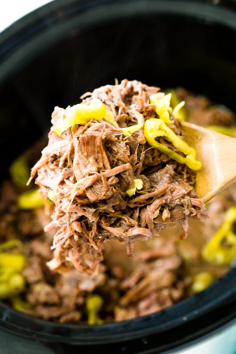 Italian Beef being scooped out of crock pot